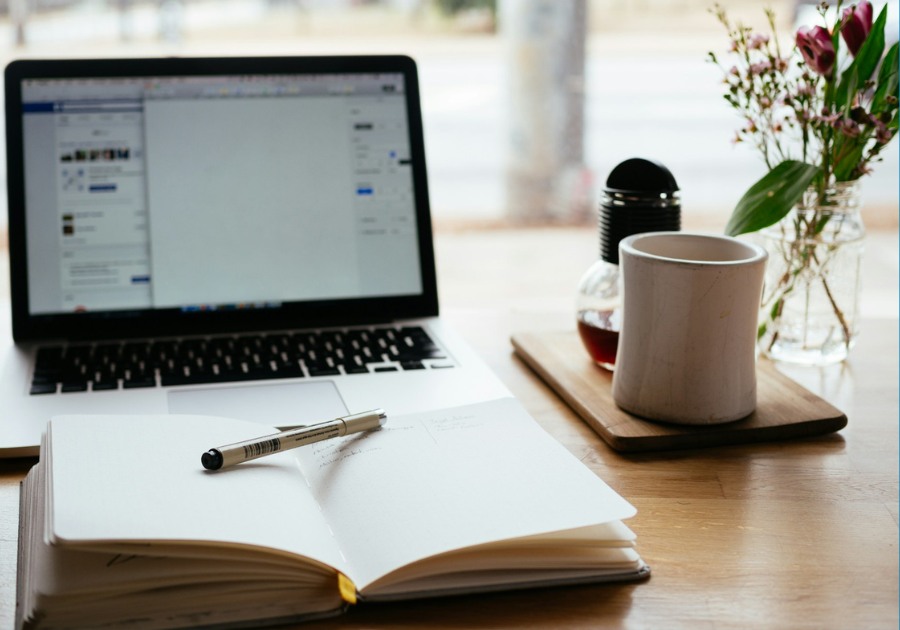 A notebook in front of a laptop